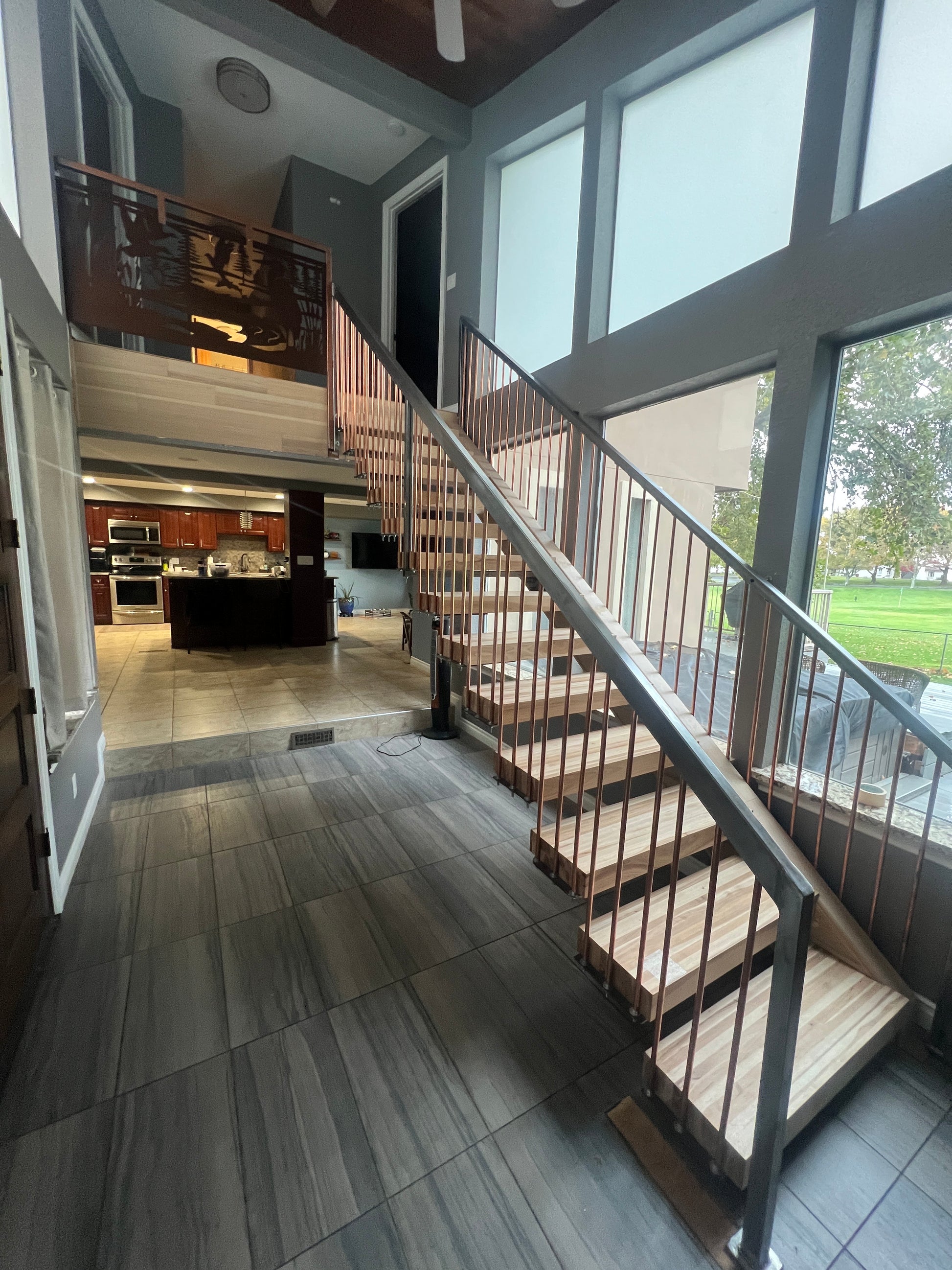 Modern interior with glass ceiling and wooden floor with stair treads by Whitewater Forest Products
